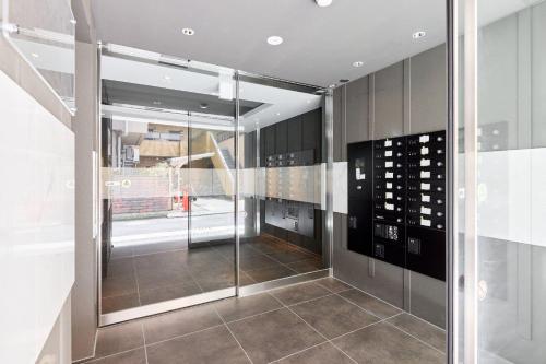a glass elevator in a building with a staircase at The Parkcross Kikukawa in Tokyo