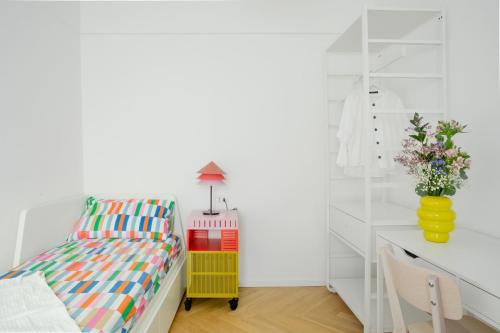 a childs bedroom with a bed and a desk at NEST LIVING - Red Velvet in Udine
