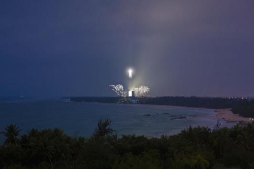 an island in the water at night with a light at Hilton Wenchang in Wenchang