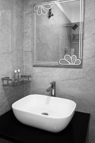 a bathroom with a white sink and a mirror at Nahargarh view Hotel in Jaipur