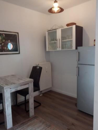 a kitchen with a table and a refrigerator at Meerforelle 207 - Villa Seeblick in Sassnitz