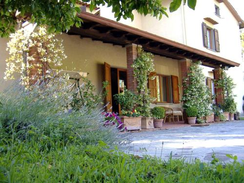 a house with potted plants on the side of it at Da Ronald ... A Pian Del Papa in Pratovecchio