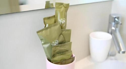 a green paper bag on a counter in a bathroom at London Hotel in Macau