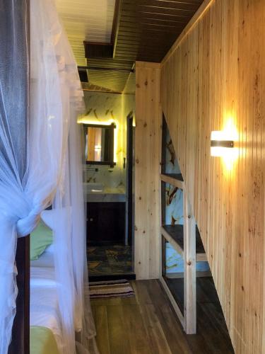 a room with a bed with a window and a bathroom at Barn Hills in Ella