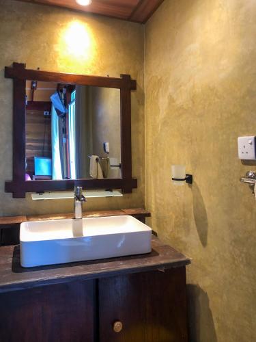 a bathroom with a sink and a mirror at Barn Hills in Ella