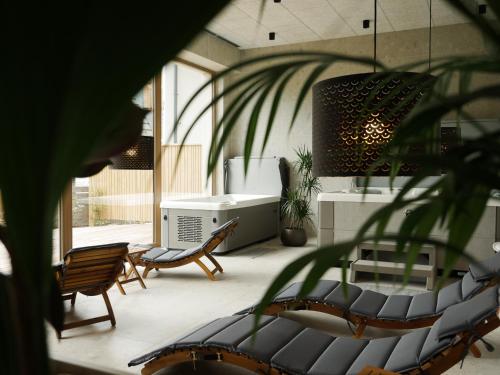 a living room with two chairs and a table at Bohinj River House in Bohinj