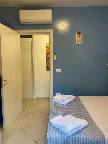two towels sitting on a bed in a room at Villaaquamarina in Torre dell'Orso