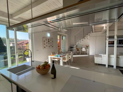 a kitchen and dining area of a house with a table at Charme Lake Loft in Ispra