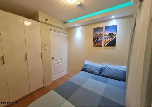 a small bedroom with a bed and a door at San Remo Oasis Cebu City U2331 in Cebu City