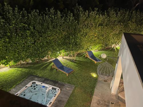 an overhead view of a backyard with a pool and trees at Villaaquamarina in Torre dell'Orso