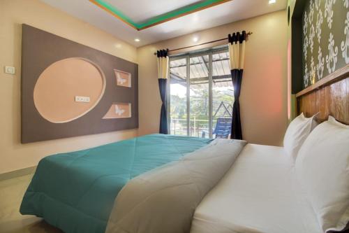 a bedroom with a large bed with a blue blanket at Lifeline Villas - Valley View Luxurious 3bhk Surrounded by strawberry farms in Mahabaleshwar
