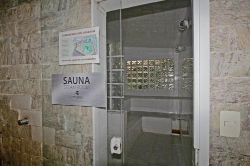 a shower stall with a sign on a wall at Conforto! Localização Imbatível em Copacabana U054 in Rio de Janeiro