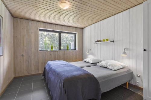 a bedroom with a bed in a room with a window at LK1443-Lokken-Oddervej-5-a in Løkken