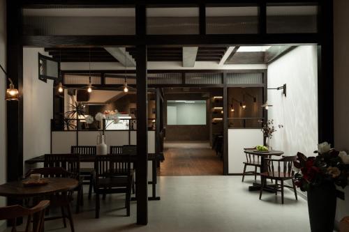 a dining room and kitchen with a table and chairs at Dali Zhi'an Hotel in Dali Ancient Town