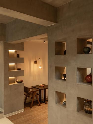 a living room with a table and a wall with shelves at Dali Zhi'an Hotel in Dali Ancient Town