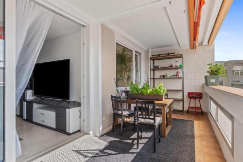 a balcony with a television and a table and chairs at Köln,Leverkusen Appartement Bahnhof,Innenstadt,Messe in Leverkusen