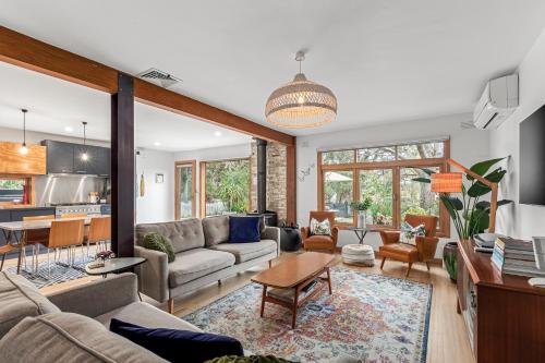 a living room with a couch and a table at Cottesloe Beach Shack Barwon Heads in Barwon Heads