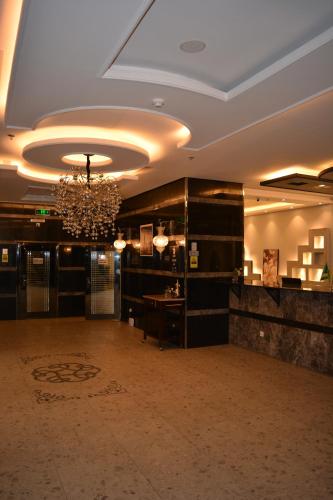 a large room with a chandelier in a building at Marina Palace Hotel in Al Madinah