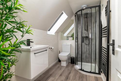 a bathroom with a toilet and a shower at Victoria Court Suites - Aberdeen in Aberdeen