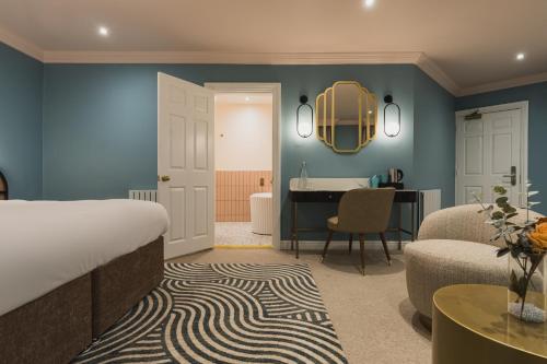 a bedroom with a bed and a desk and a bathroom at Grange Hotel in Grange Over Sands