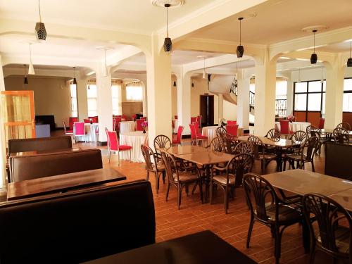 a dining room with tables and chairs and a cafeteria at OLOIRIEN HOTEL & RESORT in Narok