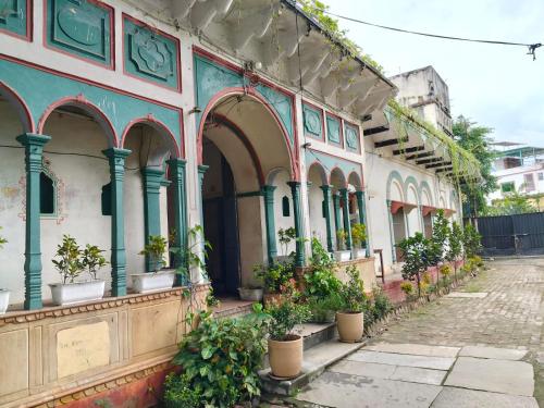 un antiguo edificio con macetas en una calle en Khurja Wali Dharamshala, en Rishīkesh