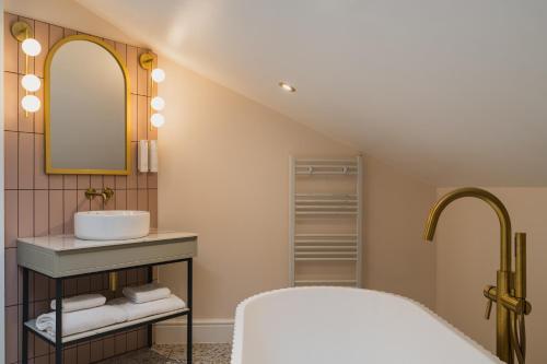 a bathroom with a sink and a mirror at Grange Hotel in Grange Over Sands