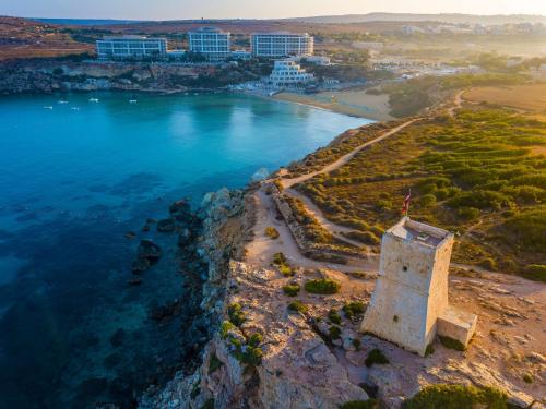 an aerial view of a castle on the edge of a body of water at Radisson Blu Resort & Spa, Malta Golden Sands in Mellieħa