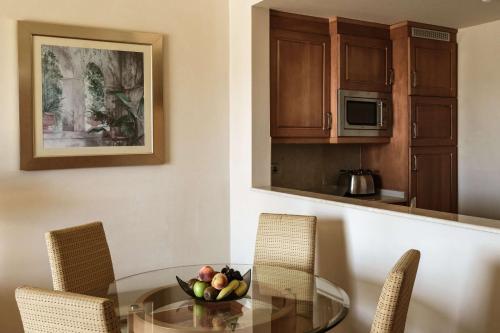 a dining room with a glass table and chairs at Radisson Blu Resort & Spa, Malta Golden Sands in Mellieħa