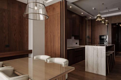 a kitchen with wooden cabinets and a glass counter top at Radisson Blu Resort & Spa, Malta Golden Sands in Mellieħa