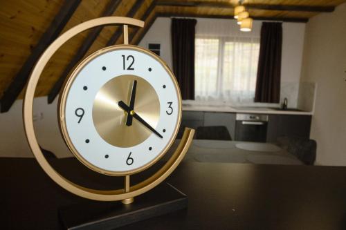a clock sitting on a table in a room at Refugiu de munte in Albac