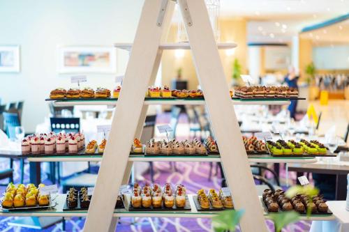 a display of different types of pastries on a ladder at Radisson Blu Resort & Spa, Malta Golden Sands in Mellieħa