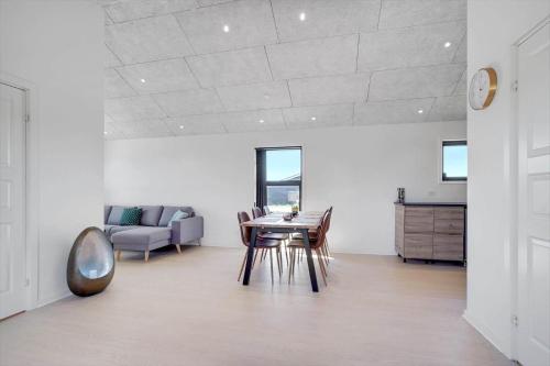 a living room with a table and chairs and a couch at LK1859-Lokken-Ulstrupvej-19 in Løkken