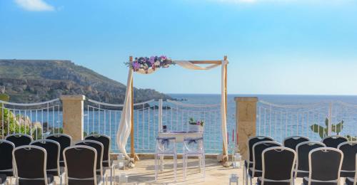 a set up for a wedding with a table and chairs at Radisson Blu Resort & Spa, Malta Golden Sands in Mellieħa