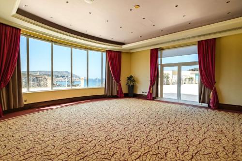 a large room with a large carpeted floor and windows at Radisson Blu Resort & Spa, Malta Golden Sands in Mellieħa
