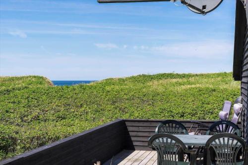 a patio with a table and chairs and the ocean at LK1863-Lokken-Ulstrupvej-21 in Løkken