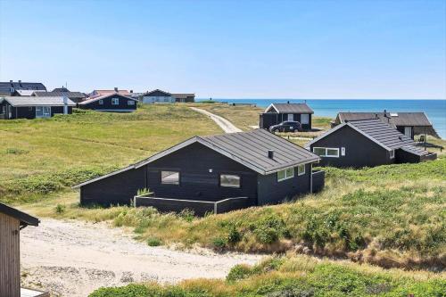 a group of houses on a hill next to the ocean at LK1863-Lokken-Ulstrupvej-21 in Løkken