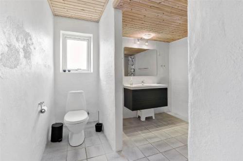 a bathroom with a toilet and a sink at LK1755-Vra-Praestegardsvej-58 in Vrå