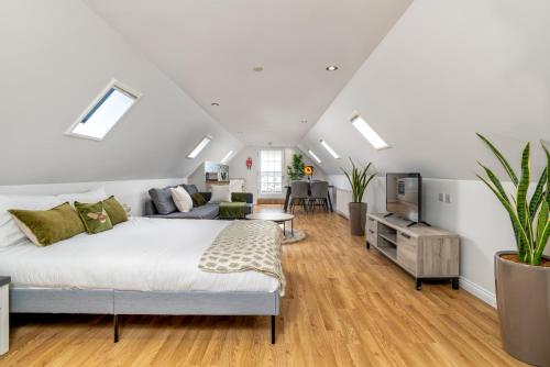 a bedroom with a bed and a living room at Victoria Court Suites - Aberdeen in Aberdeen