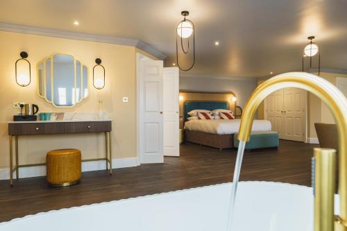 a bedroom with a bed and a sink and a mirror at Grange Hotel in Grange Over Sands