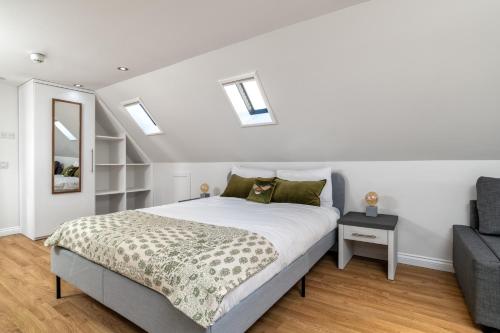 a bedroom with a bed and a couch at Victoria Court Suites - Aberdeen in Aberdeen