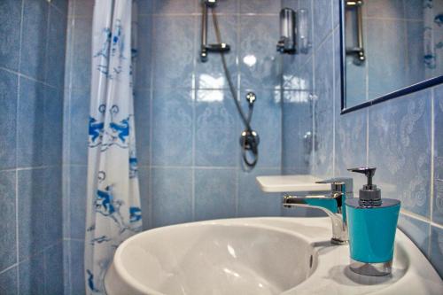 a bathroom with a sink with a cup on it at B&b Trebenoro in Lotzorai