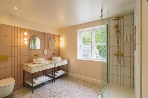 a bathroom with two sinks and a shower at Grange Hotel in Grange Over Sands