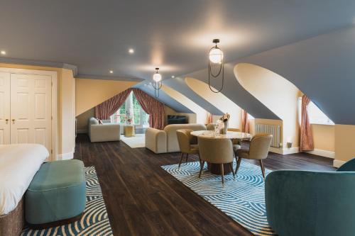 a hotel room with a bed and a table and chairs at Grange Hotel in Grange Over Sands
