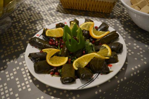 a plate of food with orange slices on a table at Marina Palace Hotel in Al Madinah