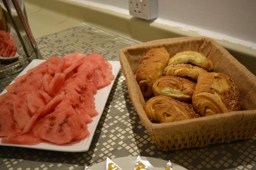 a table with a basket of food and a plate of meat at Marina Palace Hotel in Al Madinah