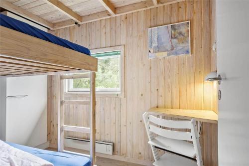 a small bedroom with a bunk bed and a desk at LK626-Lokken-Magdalenevej-40 in Løkken