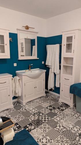 a bathroom with a white sink and blue walls at Pferdeparadies Stein 