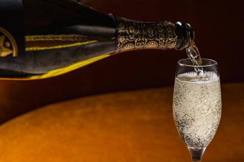 a bottle of champagne being poured into a glass at Grange Hotel in Grange Over Sands