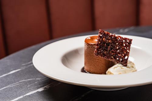 a piece of chocolate cake and ice cream on a plate at Grange Hotel in Grange Over Sands
